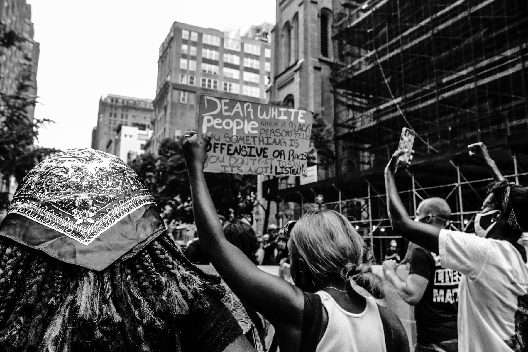 Unrecognizable diverse strikers with BLM placards protesting on street